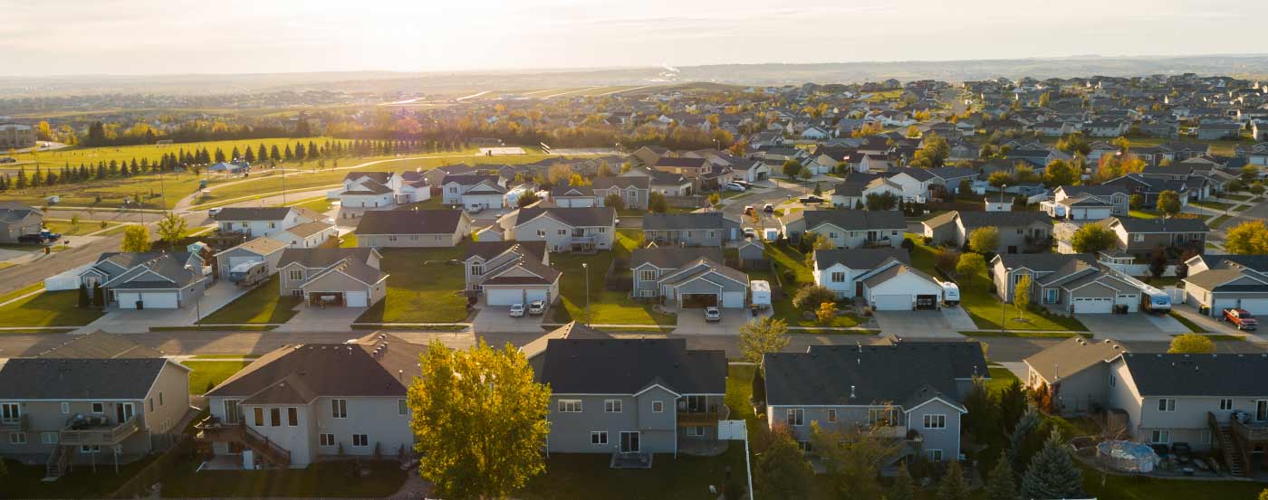 aerial view of housing development at sunset