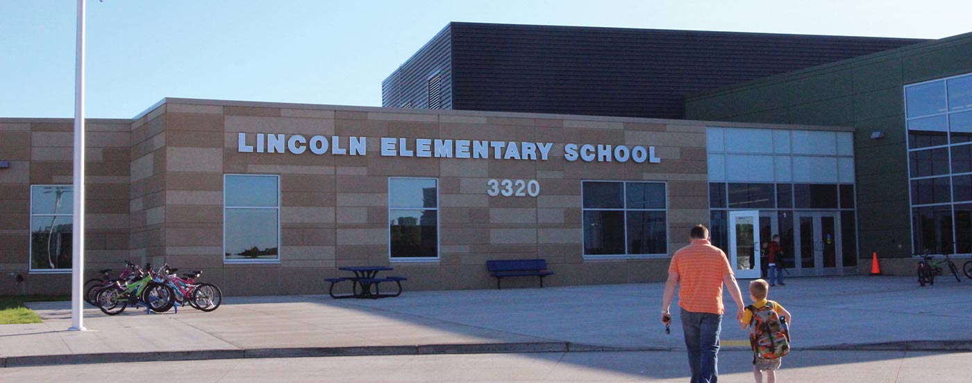 lincoln elementary school with dad and son walking up