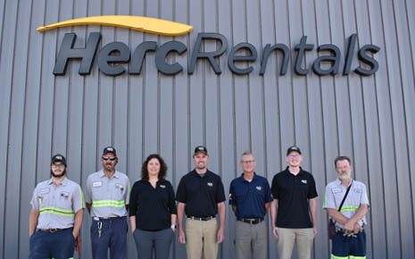 herc rentals standing in a line smiling