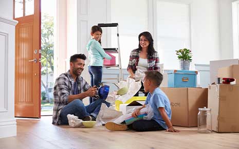 smiling family moving into home